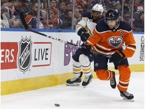Edmonton's Adam Larsson (6) is chased by Buffalo's Evander Kane (9) during the second period of an NHL game between the Edmonton Oilers and the Buffalo Sabres at Rogers Place in Edmonton, Alberta on Tuesday, Jan. 23, 2018.