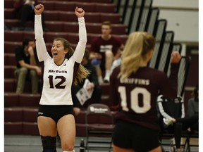 Kylie Schubert (12) celebrates with Zoe Cronin (10) during a Canada West volleyball match between the MacEwan University Griffins and the Regina Cougars in Edmonton, Alberta on Friday, Jan. 26, 2018.