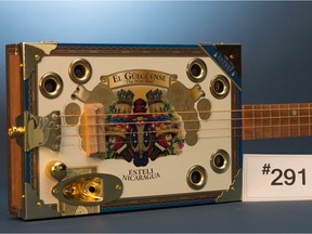 The guitar is described as a Winston and Fidel Cigar Box Guitar and was inside a soft case when stolen.