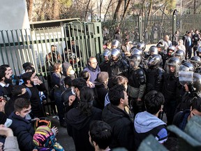 In this Dec. 30, 2017 file photo taken by an individual not employed by the Associated Press and obtained by the AP outside Iran, anti-riot Iranian police prevent university students to join other protesters over Iran weak economy, in Tehran, Iran. (AP Photo, File)