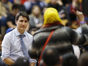 Prime Minister Justin Trudeau listens to a question about Child and Family Services at a town hall meeting at the University of Manitoba in Winnipeg, Wednesday, Jan. 31, 2018.