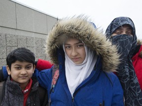 Khawlah Noman, 11, is accompanied by her brother Mohammad Zakarijja and their mom Saima Samad as she recalls a man slicing her hijab as she and her sibling walked to Pauline Johnson Public School in Scarborough on Friday, Jan. 12, 2018.