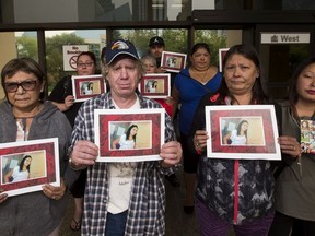 Friends and family of Lena Steinhauer hold her picture outside the Edmonton courthouse on August 30, 2017. In the front row is Helen Larson, left, Gregory Locher, mother Sheila Steinhauer and cousin, Denise Steinhauer. On Feb. 9 2015, police were called to a home at 112 Avenue and 95A Street after someone found Steinhauer's body inside.