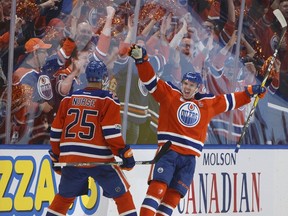 Edmonton Oilers' Darnell Nurse (25) and Connor McDavid (97) celebrate a goal against the San Jose Sharks during the third period of Game 2 of an NHL hockey Stanley Cup first-round playoff series at Rogers Place on April 14, 2017.