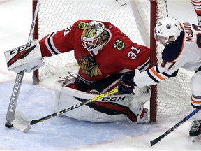 Chicago Blackhawks goalie Jeff Glass blocks a shot by Edmonton Oilers center Connor McDavid on Sunday, Jan. 7, 2018, in Chicago.