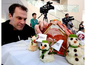Dinner TV's Jason Strudwick puts the finishing touches on the winning media gingerbread houses at the annual Christmas Bureau Kickoff at City Hall in Edmonton, Alta., on Monday Nov 16, 2015.