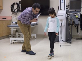 Thaer Manaseer, PhD student in the faculty of rehabilitation medicine, used his daughter Amril, 7, to demonstrate balance tests Wednesday, Jan. 17, 2018. A new University of Alberta study is hoping to bring awareness to the need for more comprehensive testing when it comes to individuals with ongoing post concussion issues.