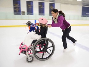 Jamie Sale pushes eight-year-old Ava Hadfield at the Royal Glenora Club on Saturday, January 27. For Cam Tait column in Edmonton Sun (Supplied)