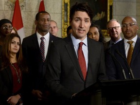 Prime Minister Justin Trudeau speaks with media during an availability in the foyer with his caucus on Parliament Hill, in Ottawa on Tuesday, January 30, 2018.