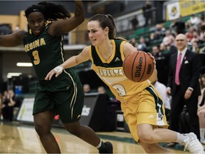 University of Alberta Pandas guard Lauren Earl, right, drives to the basket against University of Regina Cougars guard Kyanna Giles at the Saville Community Sports Centre on Friday, Jan 12, 2018.