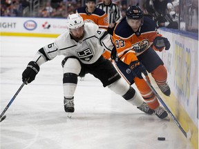 Edmonton Oilers forward Ryan Nugent-Hopkins (93) battles Los Angeles Kings defenceman Jake Muzzin (6) during third period NHL action at Rogers Place in Edmonton Tuesday, Jan. 2, 2018.