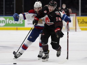 The Edmonton Oil Kings' Tomas Soustal (11) battles the Moose Jaw Warriors' Brayden Burke (19) during second period WHL action at Rogers Place in Edmonton Saturday, Jan. 6, 2018.