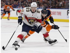 The Edmonton Oilers' Matthew Benning (83) battles the Florida Panthers' Evgenii Dadonov (63) during third period NHL action at Rogers Place in Edmonton Monday Feb. 12, 2018. Dadonov was awarded a penalty shot on the play.
