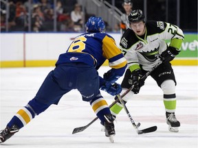 The Edmonton Oil Kings' Trey Fix-Wolansky (27) battles the Saskatoon Blades' Mark Rubinchik (6) during first period WHL action at Rogers Place in Edmonton Monday Feb. 19, 2018.