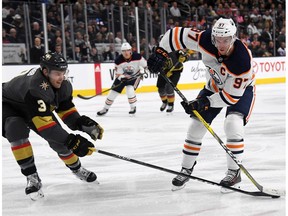 Brayden McNabb #3 of the Vegas Golden Knights knocks the puck away from Connor McDavid #97 of the Edmonton Oilers in the first period of their game at T-Mobile Arena on February 15, 2018 in Las Vegas, Nevada.