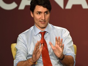 Canadian Prime Minister Justin Trudeau speaks during a business summit in Mumbai on February 20, 2018. Trudeau met India's corporate titans on February 20 as he pursued a tour of the country marred by reports he has been snubbed by political leaders. Trudeau addressed a business conference in Mumbai on February 20 morning, attended by leaders from the Tata conglomerate, IT giants Infosys and pharmaceutical major Jubilant Life Sciences. Trudeau and his family are on a week-long official trip to India.