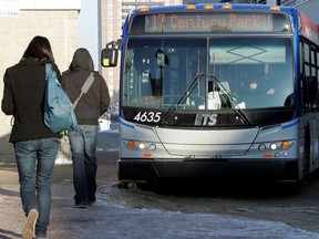 Transit users board a bus at the Southgate transit terminal, Dec. 22, 2010.