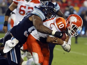 Jonathon Jennings of the BC Lions is sacked by Victor Butler of the Toronto Argonauts during CFL action in Toronto, Ont. on Friday June 30, 2017. (Veronica Henri/Postmedia Network )
