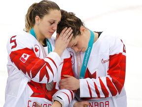 Canada defenceman Lauriane Rougeau and Canada forward Rebecca Johnston console each other after losing to the United States.
