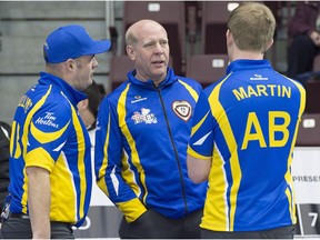 Canadian curling great Kevin Martin, coach of the Alberta team, talks with Darren Moulding, left, and his son Karrick Martin during draw 6 action against New Brunswick at the Tim Hortons Brier curling championship at Mile One Centre in St. John's on Monday, March 6, 2017.