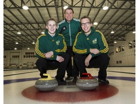 Thomas Scoffin, front left, and Brendan Bottcher are photographed with their coach, Rob Krepps, at the Saville Centre in Edmonton on Jan. 31, 2013. (File)