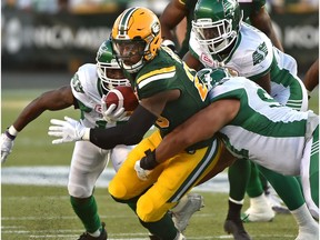 Edmonton Eskimos Pascal Lochard (25) about to be tackle by Saskatchewan Roughriders during CFL action at Commonwealth Stadium in Edmonton, August 25, 2017.