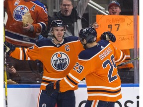 Edmonton Oilers' Connor McDavid (97) and Leon Draisaitl (29) celebrate a goal against the Tampa Bay Lightning during second period NHL action in Edmonton, Alta., on Monday February 5, 2018.