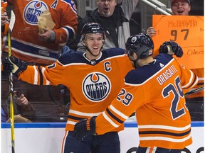 Edmonton Oilers' Connor McDavid (97) and Leon Draisaitl (29) celebrate a goal against the Tampa Bay Lightning during second period NHL action in Edmonton on Monday February 5, 2018.