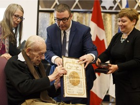 Hartgert van Engelen (seated, left) receives the Righteous Among the Nations Award on behalf of his late parents, Albertus and Gerrigje van Engelen, from Consul General of Israel in Toronto and Western Canada Galit Baram (right) and program and development officer with Yad Vashem Josh Hacker. Van Engelen's daughter Claudia Kobayashi is at left. The event took place at Beth Israel Synagogue in Edmonton on Tuesday, Feb. 20, 2018.