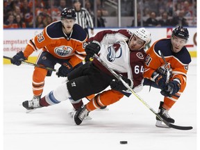 Edmonton's Yohann Auvitu (81) knocks down Colorado's Nail Yakupov (64) during the second period of a NHL game between the Edmonton Oilers and the Colorado Avalanche at Rogers Place in Edmonton on Feb. 22, 2018.