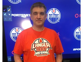 Edmonton Oilers head equipment manager Jeff Lang wears a T-shirt marking his 1,000th National Hockey League game worked ahead of Monday's game against the Tampa Bay Lightning at Rogers Place in Edmonton, Feb. 5, 2018.