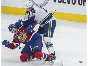 Nick Bowman of the Edmonton Oil Kings, is roughed up by Max Patterson of the Swift Current Broncos at Rogers Place  in Edmonton on February 25.  Photo by Shaughn Butts / Postmedia