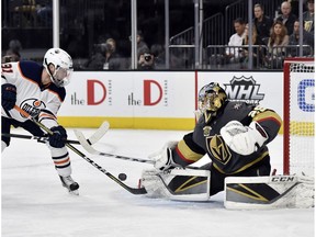 Vegas Golden Knights goalie Marc-Andre Fleury (29) defends against Edmonton Oilers center Drake Caggiula during the first period of an NHL hockey game Thursday, Feb. 15, 2018, in Las Vegas.