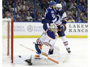 Edmonton Oilers goalie Laurent Brossoit (1) makes a save on a shot by the Tampa Bay Lightning on Feb. 21, 2017, in Tampa, FL., as the Lightning's Cedric Paquette (13) looks for a rebound. (File)