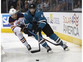 San Jose Sharks defenseman Marc-Edouard Vlasic (44) and Edmonton Oilers right wing Jesse Puljujarvi (98) race for the puck during the second period of an NHL hockey game Saturday, Feb. 10, 2018, in San Jose, Calif.
