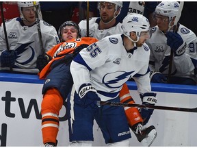 Edmonton Oilers captain Connor McDavid (97) gets hit into the Tampa Bay Lightning bench by Braydon Coburn at Rogers Place in Edmonton on Monday, Feb. 5, 2018. (Ed Kaiser)