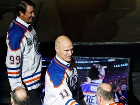Mark Messier shakes hands with a fan as Wayne Gretzky walks past during the NHL's Greatest Team celebration recognizing the 1984-85 Edmonton Oilers team at Rogers Place in Edmonton on Sunday, Feb. 11, 2018.