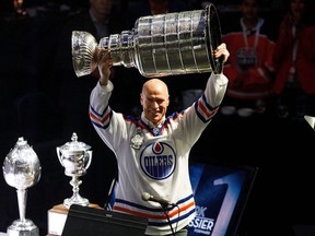 Mark Messier hoists the Stanley Cup during the NHL's Greatest Team celebration recognizing the 1984-85 Edmonton Oilers team at Rogers Place in Edmonton on Sunday, Feb. 11, 2018.