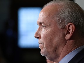 Premier John Horgan answers questions about the Alberta dispute during a press conference at the Legislature in Victoria, B.C., on Wednesday February 7, 2018. THE CANADIAN PRESS/Chad Hipolito ORG XMIT: CAH400