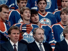 Not so official portrait. Just behind Edmonton Oilers President, General Manager and Head Coach Glen Sather (left ) and team owner Peter Pocklington having a light moment during the official team photo are left to right, Mark Messier, Wayne Gretzky, Paul Coffey and Jari Kurri at the Northlands Coliseum on June 2, 1985. The Oilers won their second Stanley Cup Championship by beating the Philadelphia Flyers in five games on May 30, 1985 in Edmonton.