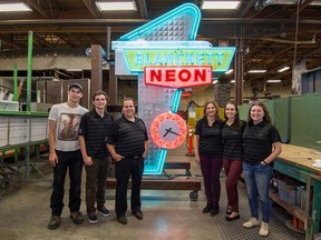 Daryl Blanchett, president of Blanchett Neon, and his wife Denise pose with their family at the company's plant just off the St. Albert Trail in Edmonton. (Supplied)