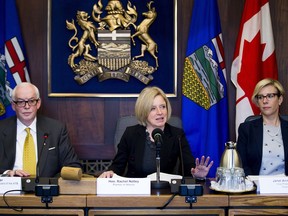 Vice Chair of the Board of ATB Financial Jim Carter, left, and Vice President of Husky Janet Annesley, right, listen as Alberta Premier Rachel Notley speaks at the first meeting of the Market Access Task Force, convened to respond to B.C. in the fight over the Trans Mountain pipeline, Wednesday, Feb. 14, 2018.