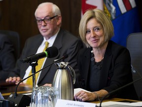 Former Syncrude Canada president Jim Carter, left, listens as Alberta Premier Rachel Notley speaks at the first meeting of the Market Access Task Force, convened to respond to B.C. in the fight over the Trans Mountain pipeline. Taken on Wednesday, Feb. 14, 2018 in Edmonton. Greg Southam / Postmedia