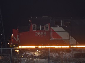 A locomotive sits on an angle after this CN train struck a semi-truck low-boy carrying a back hoe, derailing 14 train cars and two locomotives as CN crews are on site working on the cleanup in the town of Wabamun about 75 km west of Edmonton, February 8, 2018. Ed Kaiser/Postmedia