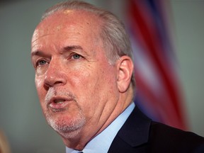 British Columbia Premier John Horgan responds to questions during a news conference in Vancouver, B.C., on Friday, February 2, 2018.