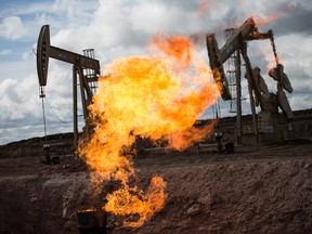 A gas flare is seen at an oil well site on July 26, 2013 outside Williston, North Dakota.