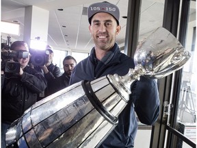 Toronto Argonauts quarterback Ricky Ray holds the Grey Cup as speaks to members of the media as the teams returns to Toronto on Monday, November 27 2017.