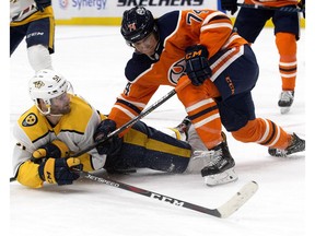 Edmonton Oilers defenceman Ethan Bear (74) battles the Nashville Predators' Austin Watson (51) at Rogers Place in Edmonton on Thursday, March 1, 2018. The Predators won 4-2. (David Bloom)