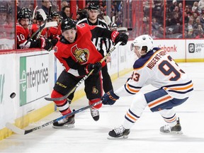 OTTAWA, ON - MARCH 22:  Cody Ceci #5 of the Ottawa Senators chips the puck past Ryan Nugent-Hopkins #93 of the Edmonton Oilers in the second period at Canadian Tire Centre on March 22, 2018 in Ottawa, Ontario, Canada.