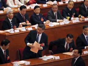 Chinese President Xi Jinping, front row second from left, and Premier Li Keqiang, second from right, proceed to cast their votes for an amendment to China's constitution that will abolish term limits on the presidency and enable Xi to rule indefinitely, during a plenary session of the National People's Congress at the Great Hall of the People in Beijing, Sunday, March 11, 2018.